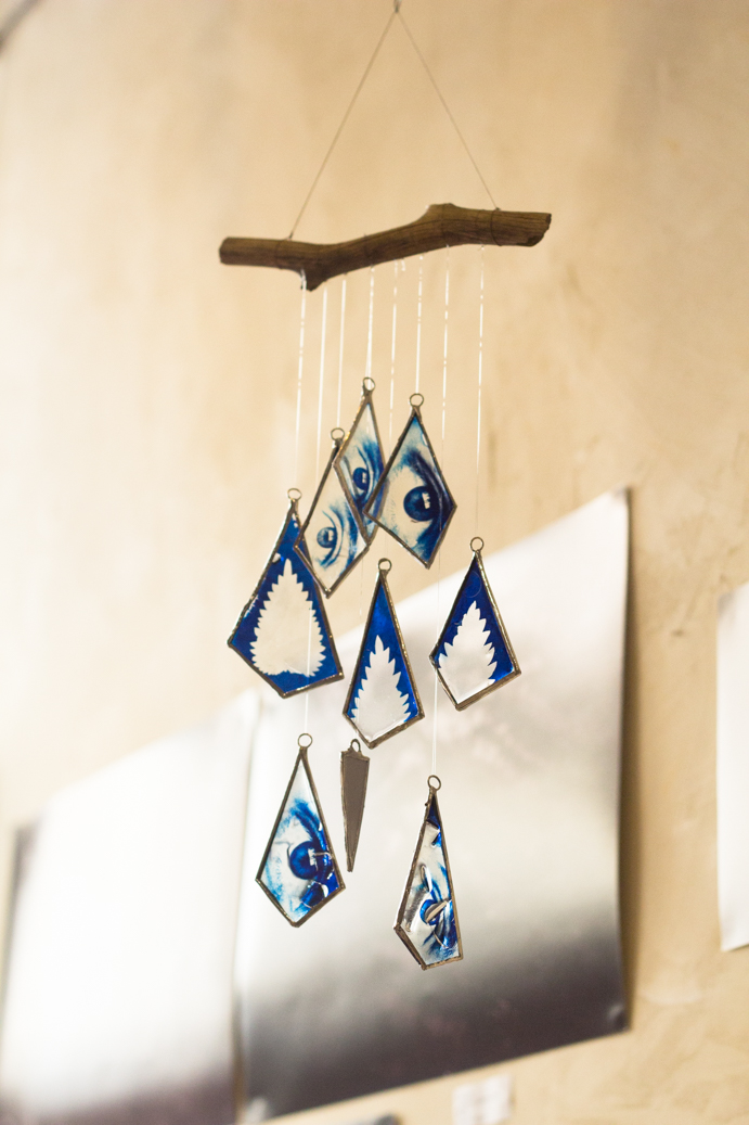 a mobile made with cyanotype prints of my eyes and fern leaves on glass.